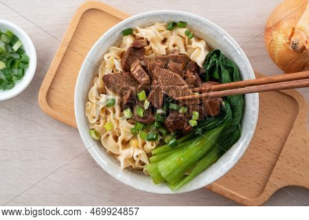 Beef Noodle Soup. Taiwanese Famous Food In A Bowl On Wooden Table.