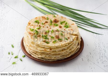 Traditional Tatar Flatbread, Kastyby And A Bunch Of Green Onions On A Light Gray Background