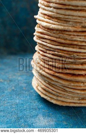 Flatbread Lavash, Chapati, Naan, Heap Of Tortilla On A Blue Background Homemade Flatbread Stacked.