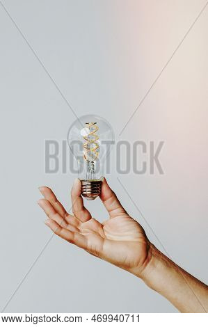 A Image Of Hand Holding A Light Bulb