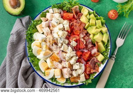 Tradition Cobb Salad With Fried Chicken, Avocado, Fresh Tomatoes, Eggs, Bacon And Cheese On A Plate 