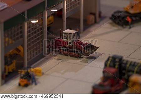 Models Of Cars Of Construction Equipment Leave The Garage, Excavators And Loaders.