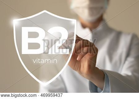 Molecular Model Of Vitamin B2, Riboflavin. Shield In Doctor`s Hands With Vitamin B2.