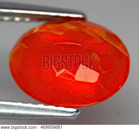 Natural Gemstone Fire Opal On Gray Background