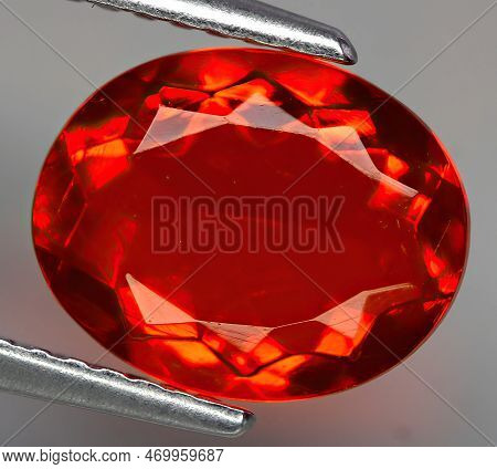 Natural Gemstone Fire Opal On Gray Background