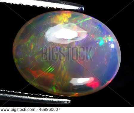 Natural Gemstone Rainbow Opal On Gray Background