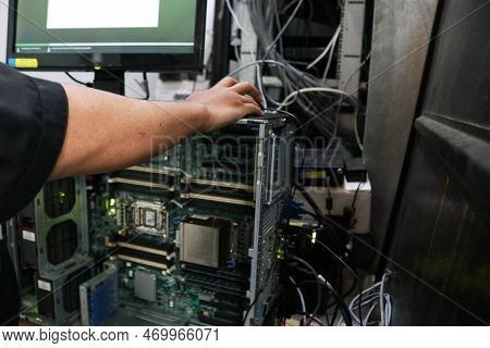 A Repairman In The Server Room Repairs Server Computers, Networks And Cables