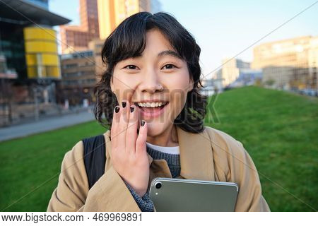 Image Of Korean Girl With Happy Face, Walks Around Town With Student Tablet, Stands On Street And Sm