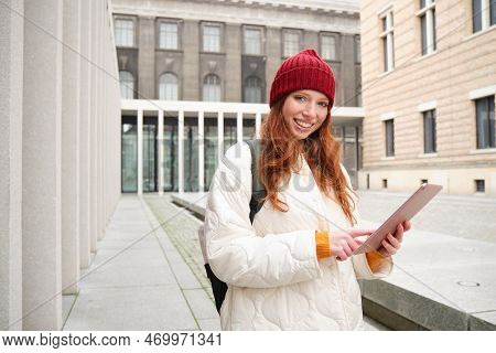 Stylish Ginger Girl, Tourist Walks With Digital Tablet Around City, Woman Connects To Iternet On Her
