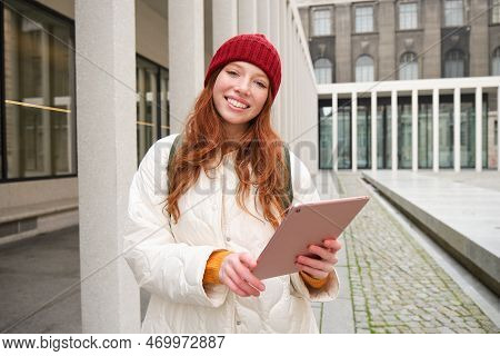 Stylish Ginger Girl, Tourist Walks With Digital Tablet Around City, Woman Connects To Iternet On Her