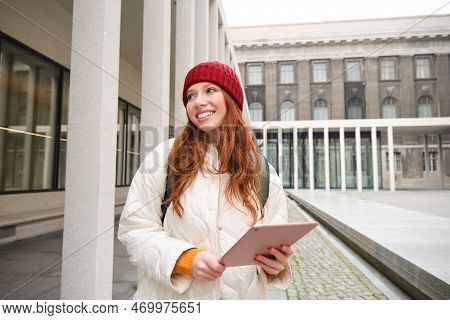 Stylish Ginger Girl, Tourist Walks With Digital Tablet Around City, Woman Connects To Iternet On Her