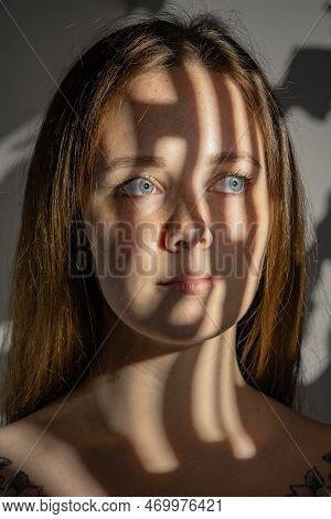 Studio Portrait Of Young Sad Beautiful Woman Using Gobo Masks