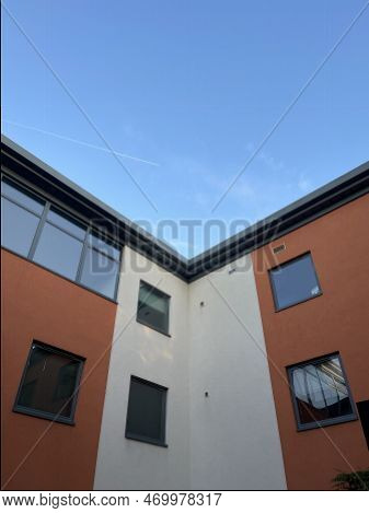 Low Angle Symmetric Shot Of A Modern Building Under Blue Sky