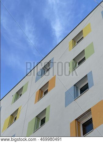 Lovely Residential Building With Colorful Windows Under Blue Sky