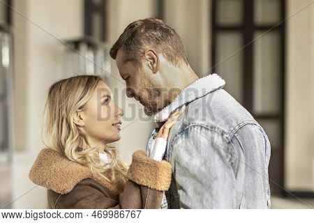 A Smiling Couple Is In Love Outdoors.a Young Happy Couple Embraces On A City Street.