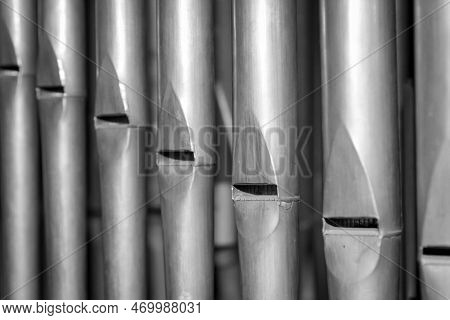 Metal Pipes Of A Church Organ, Close-up. Background. Many Organ Pipes Stand Side By Side In An Organ