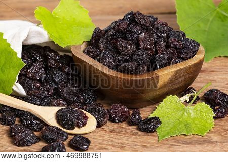 Healthy Food - Nuts Dehydrated Grapes; Photo On Wooden Background