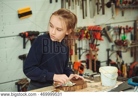 Artisan Boy Is Putting A Protective Mordant On The Wood. Cute Boy Makes Wooden Clock In The Workshop