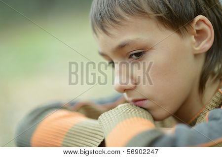 sad little boy outdoors in autumn