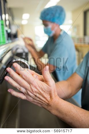 Detail of surgeon doing a surgical scrub on hands and arms