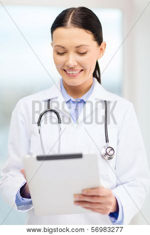 healthcare, technology and medicine concept - smiling young doctor with tablet pc computer and sthethoscope in cabinet
