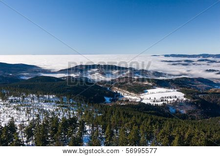 View of a low clouds on winter mountain ridge