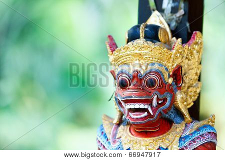 Close up of a traditional Balinese God statue in Bali temple