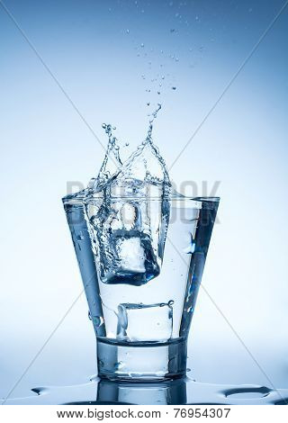water splash in glass isolated on white