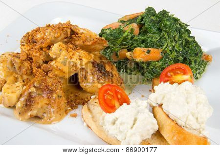Chicken with sauce and garnish.