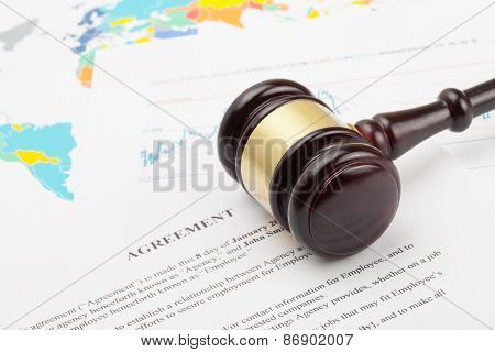 Wooden Judge's Gavel And Calculator Over Some Financial Documents