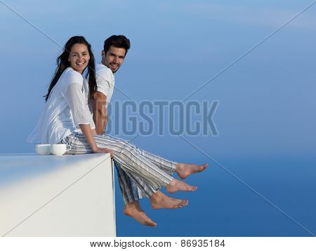 happy young romantic couple have fun relax smile at modern home outdoor terace balcony terace