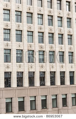 A cropped view of a beige stone cladding building