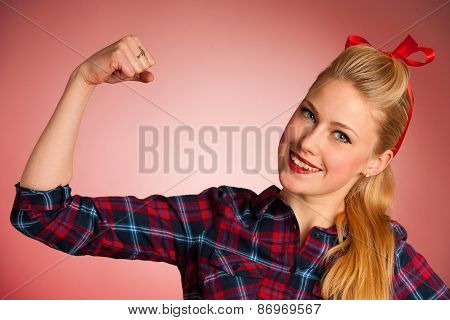 Beautiful Young Blond Pinup Woman Gesturing We Can Do It Over Red Background