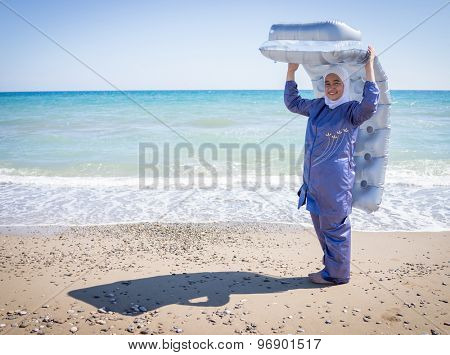 Happy Muslim girl, on summer vacation with swimming suit