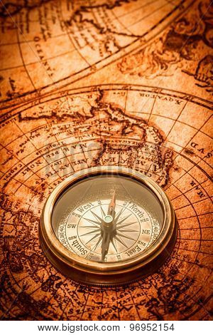 Vintage still life. Vintage compass lies on an ancient world map in 1565.