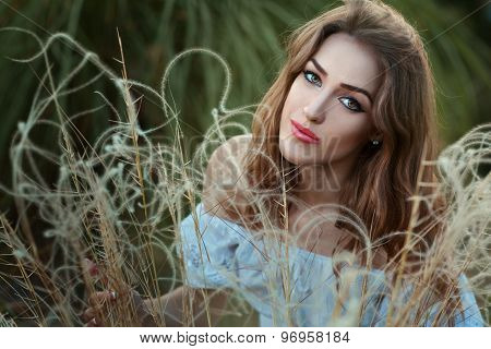 Portrait Of A Girl In Dry Grass.