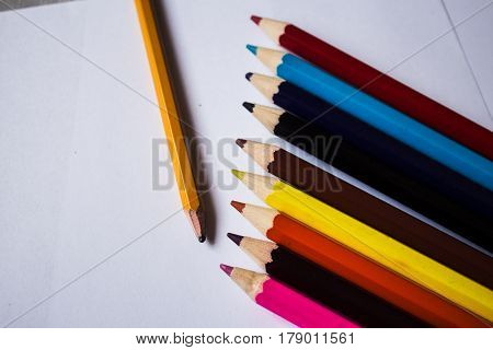 color pencils and pencil folded in a row