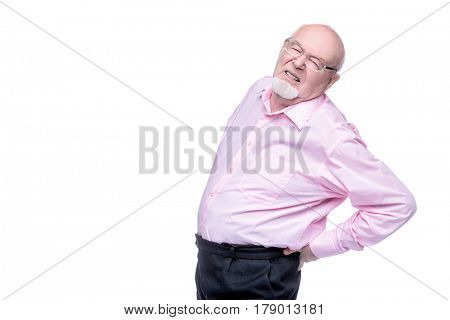The old man keeps hands on his back. Back hurts, radiculitis. Health care for the elderly people.