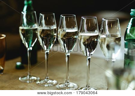 Champagne sparkles in the crystal glasses on the table