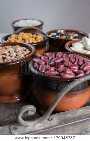 Assortment of beans on black wooden background. Soybean red kidney bean black beanwhite bean red bean and brown pinto beans