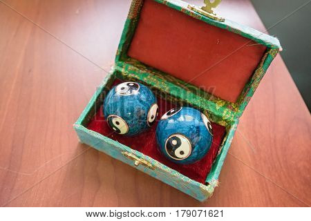 Closeup of two beautiful blue chinese meditation balls in green box