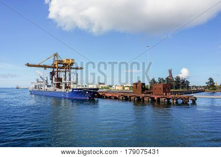 Labuan,Malaysia-Mac 25,2017:A large bulk carrier supplying iron ore in Antara Steel Mill Plant port at Labuan,Malaysia.The company produces billets and bars including angle bars and U-channels.