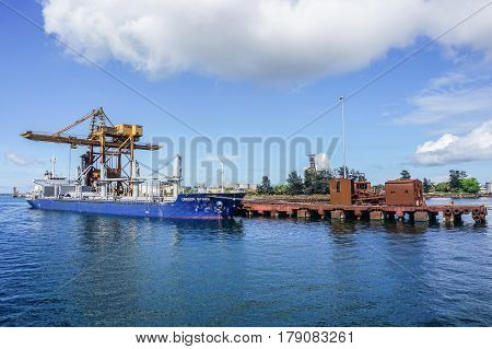 Labuan,Malaysia-Mac 25,2017:A large bulk carrier supplying iron ore in Antara Steel Mill Plant port at Labuan,Malaysia.The company produces billets and bars including angle bars and U-channels.