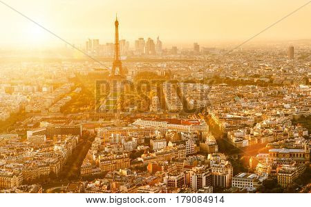 Aerial panoramic view of Paris with the Eiffel tower at sunset. La Defense district in the background.