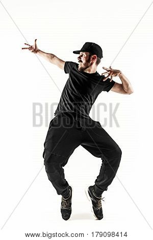 The silhouette of one young hip hop male break dancer dancing on white background