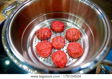 Six tasty meat cutlets in a saucepan