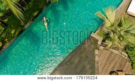 Beautiful sexy woman relaxed in pool after spa having fun at her vacation in luxury resort