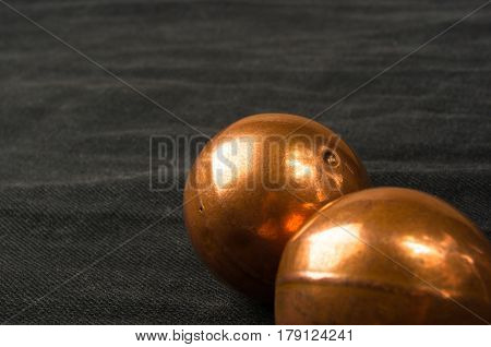 pair of copper Chinese singing balls Baoding of health for hands on black background