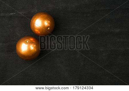 pair of copper Chinese singing balls Baoding of health for hands on black background