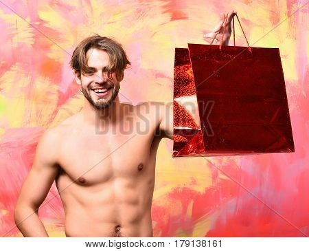Caucasian Bearded Sexy Macho Man Holding Red Package Or Bag